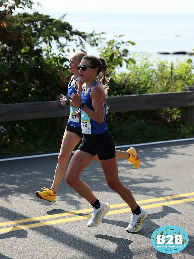 Michelle Lilienthal and Heather Gallant on Shore Road at Beach to Beacon 2025.