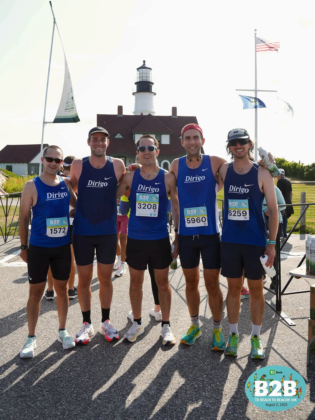 Dirigo runners in blue team singlets near a lighthouse at a road race. Instagram source image pending final approval.