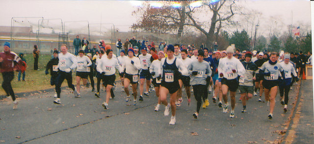 Runners starting a road race with Dirigo athletes visible in the field.