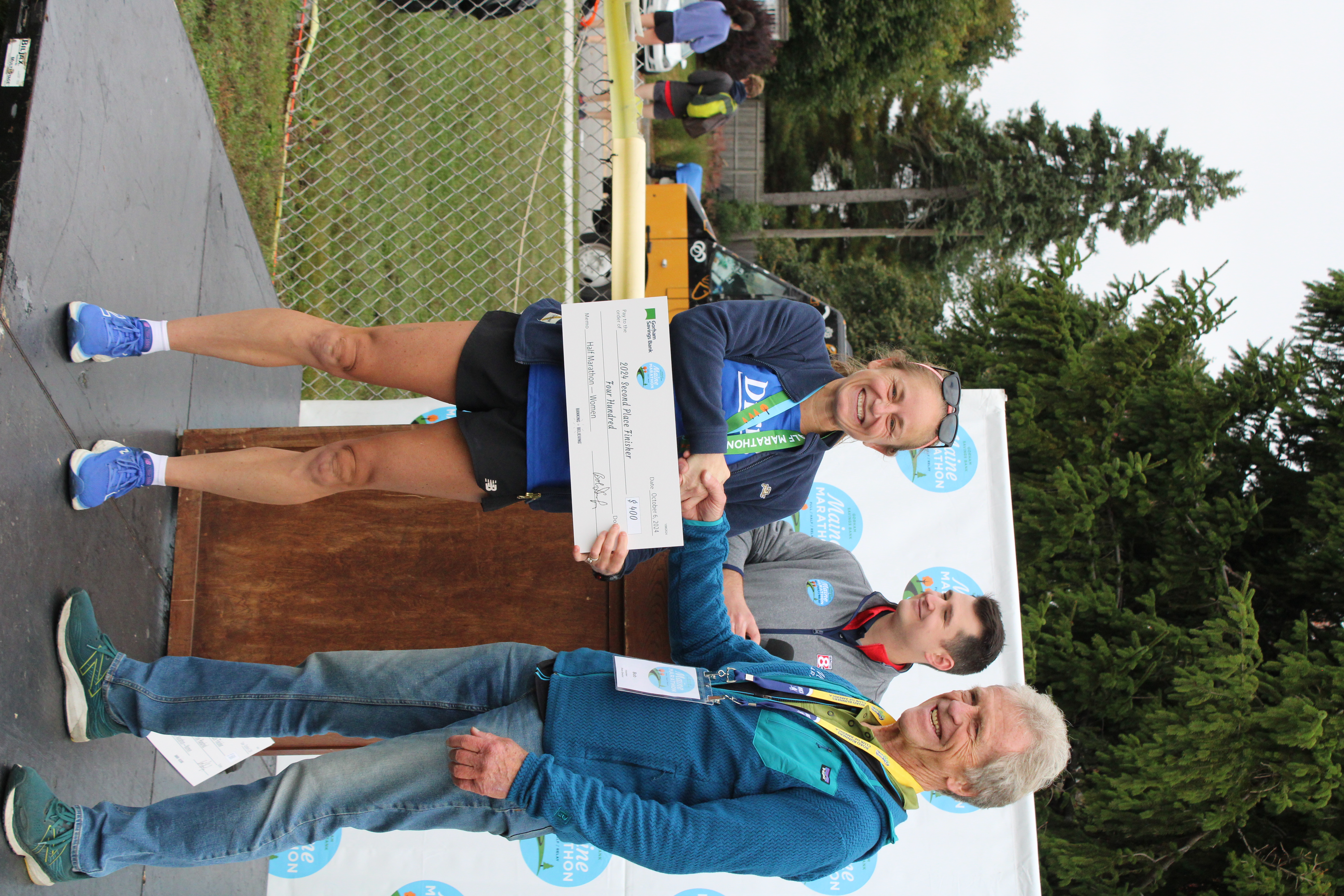 Veronica Graziano receiving her second-place women's half marathon award at the 2024 Maine Marathon weekend.